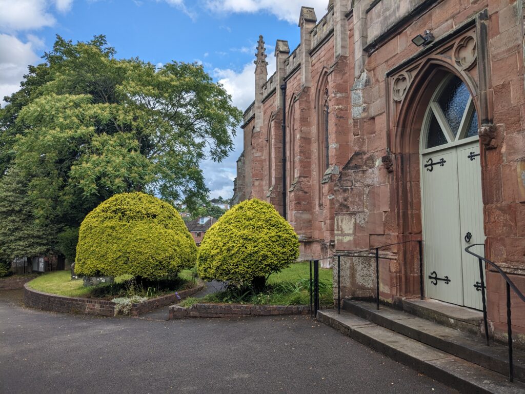 The Porch Of St Mary's Church surrounded by plants