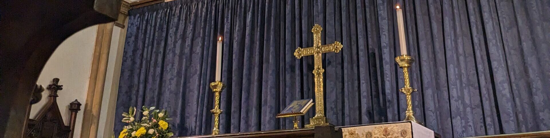 Photo of the altar in St Mary's showing candles and a cross.