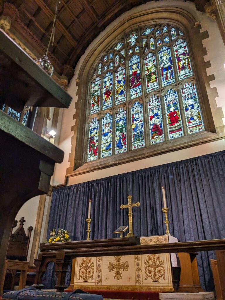 The grand stained glass window above the altar